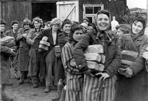 Female survivors holding bread, Bergen-Belsen, Germany