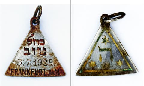 שני הצדדים של התליון נושא את הכתובת "מזל טוב" ואת האות ה' מוקפת במגני דוד