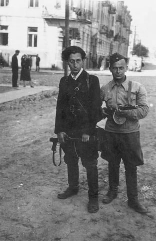 Armed partisans Abba Kovner (left) and Shmerke Kaczerginski in Joniškis, Lithuania, 1944