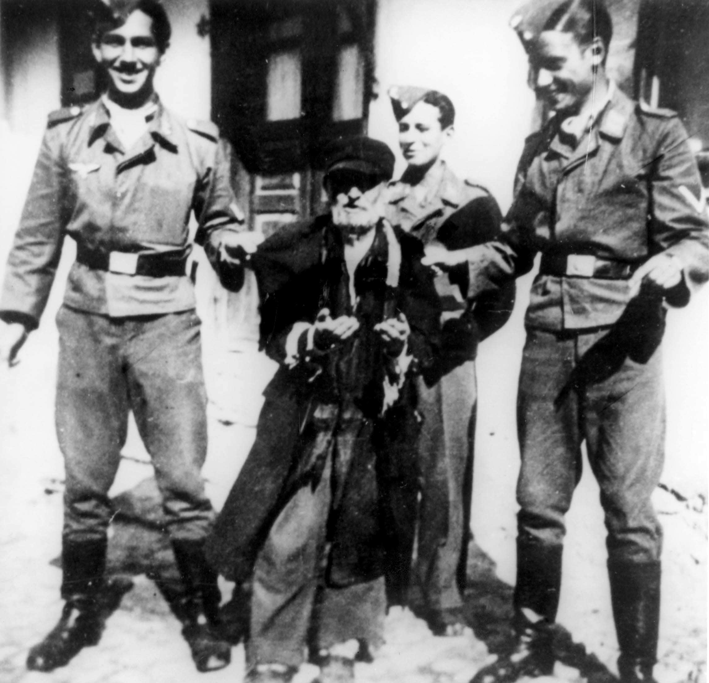 Three German air force men humilitating an elderly Jew, summer of 1941