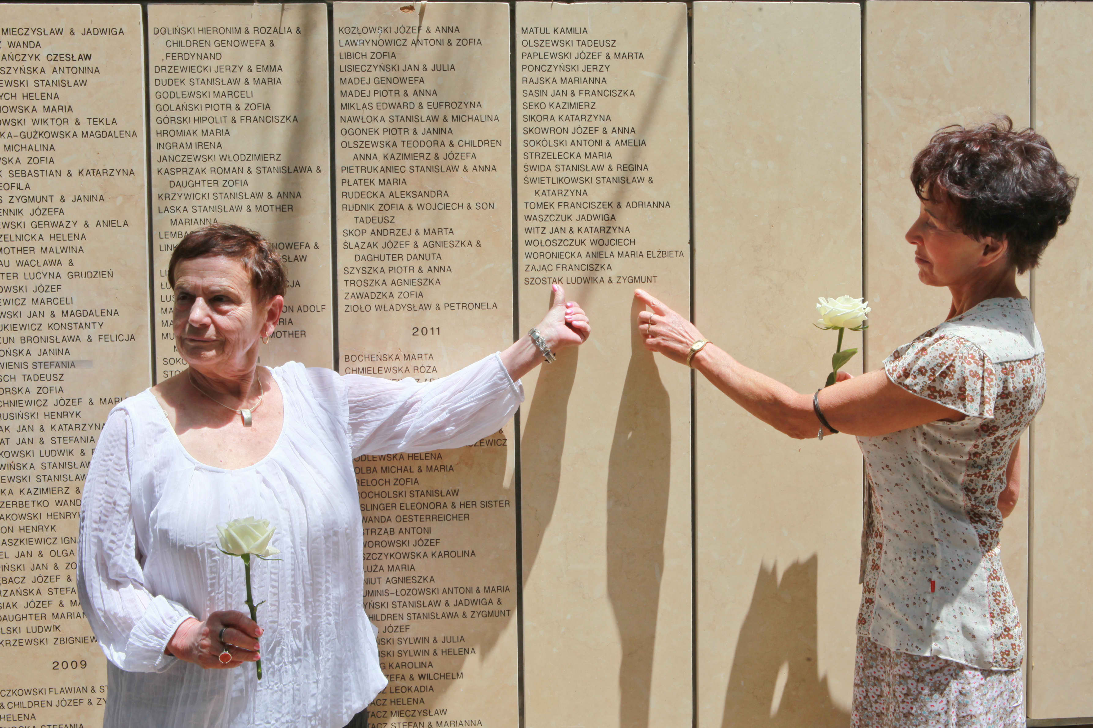 Survivor Karolina Eisen and Elzbieta Stradowska, great-niece of the late Righteous Ludwika & Zygmunt Szostak, at the wall where the names of the Righteous are engraved, Yad Vashem, 13 May 2013