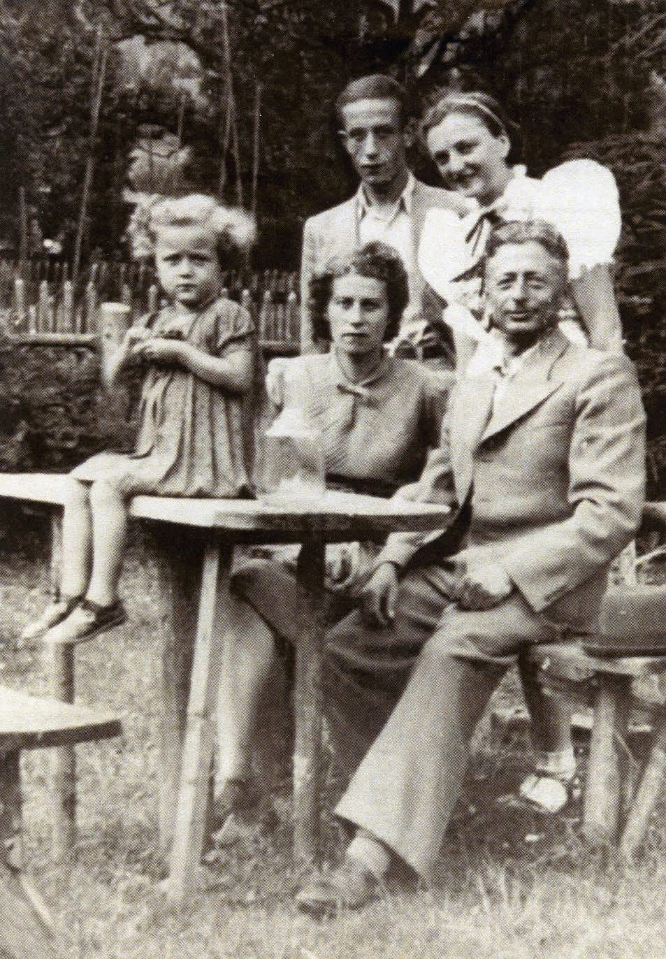 Little Sala Armel with parents Feiga and Israel and brother Jozef Joel with young woman