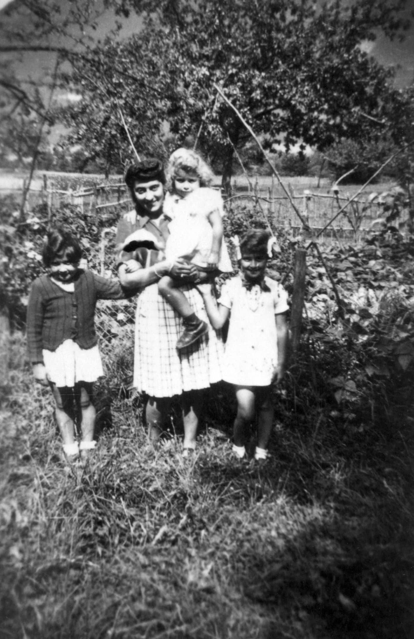 Jeannette Brousse (center), Danielle Goldman Schilli (left), Hicole Naomi Schilli (right), and Francoise Schilli in Brousse's arms