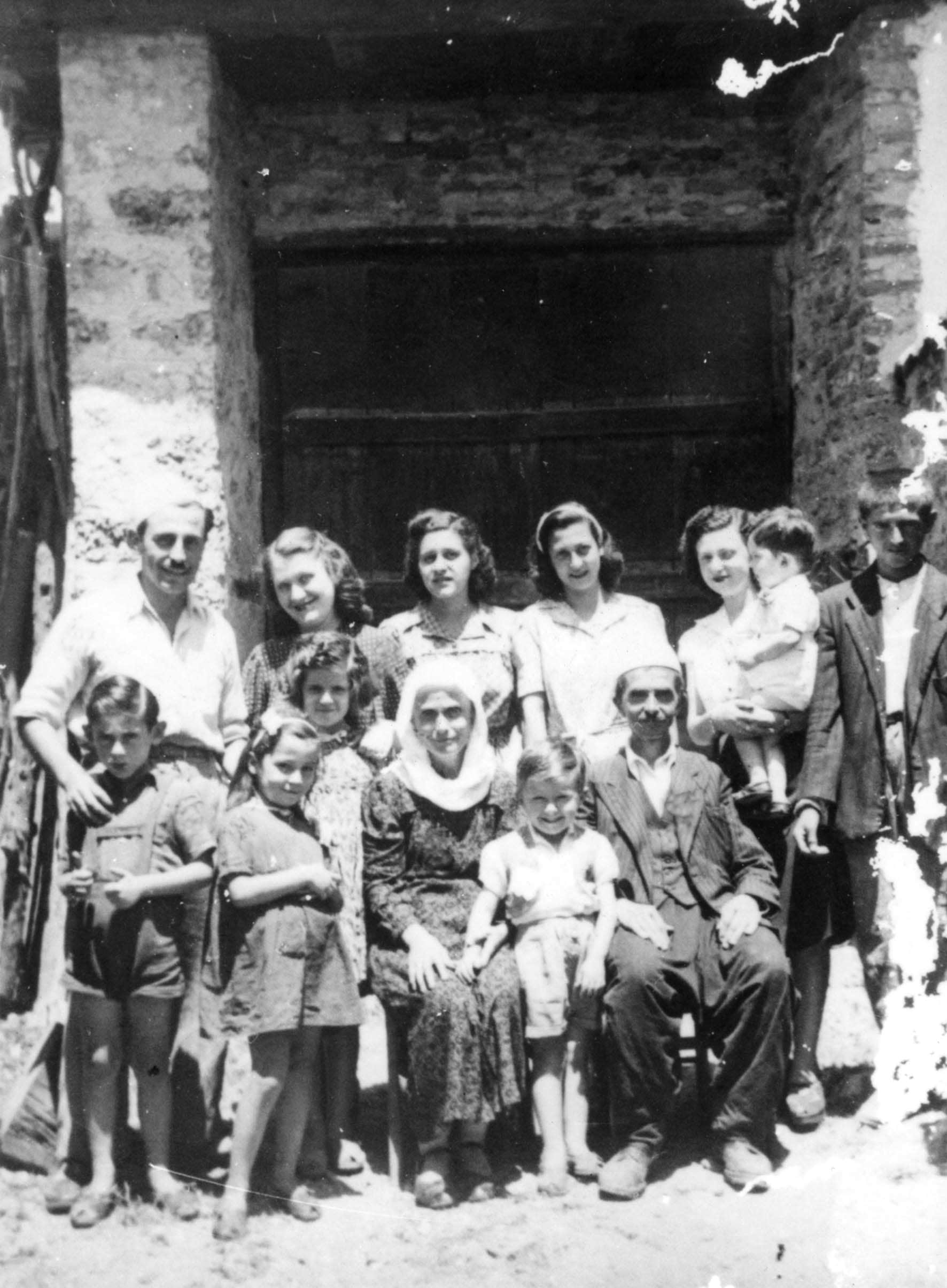 Back of the photograph, Fatima and Vesel Veseli (seated) with the Mandil family, Kruja