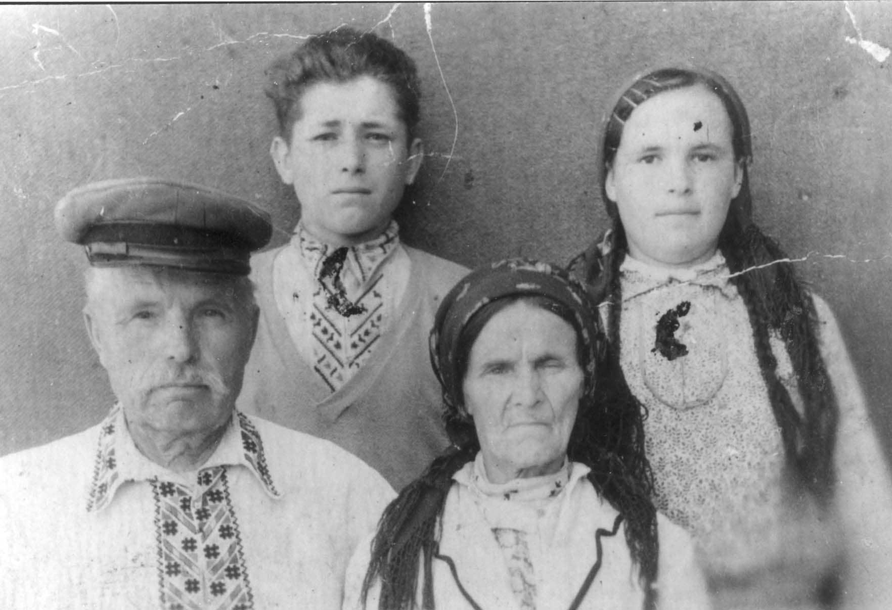 The Melnik family. Sitting: Andrey and Anna Melnik . Standing: Their daughter and her cousin. 1947, The Melnik family. Sitting: Andrey and Anna Melnik Andrey. Standing: Their daughter and her cousin. 1947, The Melnik family. Sitting: Andrey and Anna Melnik. Standing: their daughter and her cousin. 1947