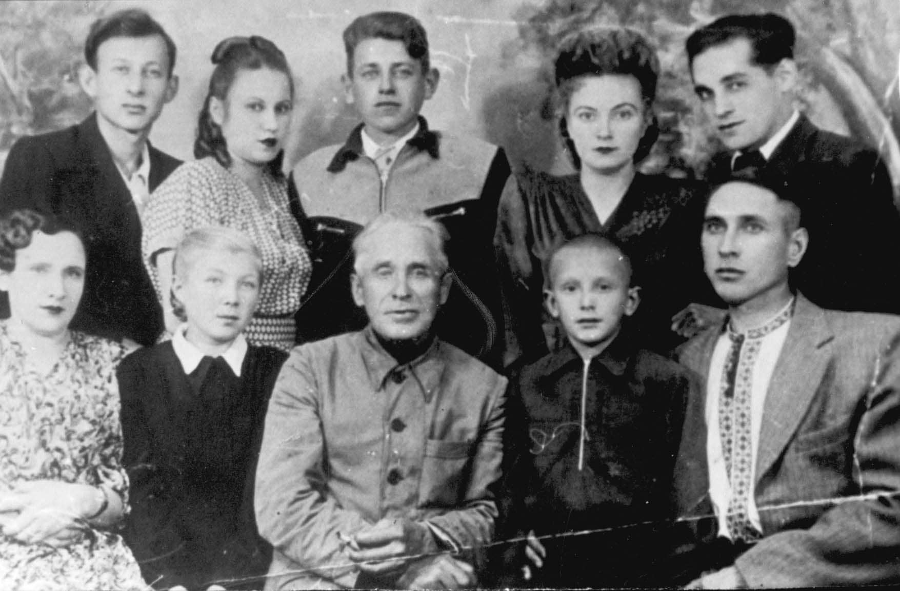 The rescuer is sitting in the centre, The rescuer is standing (the second one on the left), The rescuer is standing (the second one on the right)