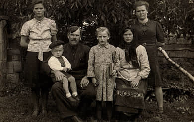 BACK PHOTO, Omelian Fisiuk (with moustache), his wife Ustinia (with dark shawl) and their family members. 1950